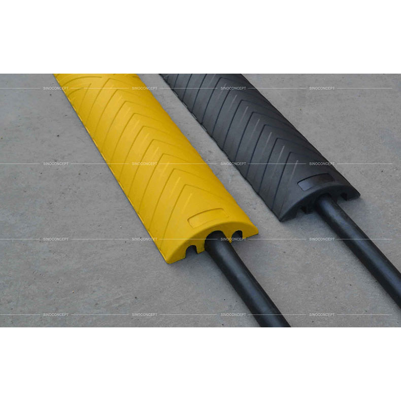 Black or yellow outdoor cable protectors also called cable ramps made of vulcanized rubber used for floor cable management